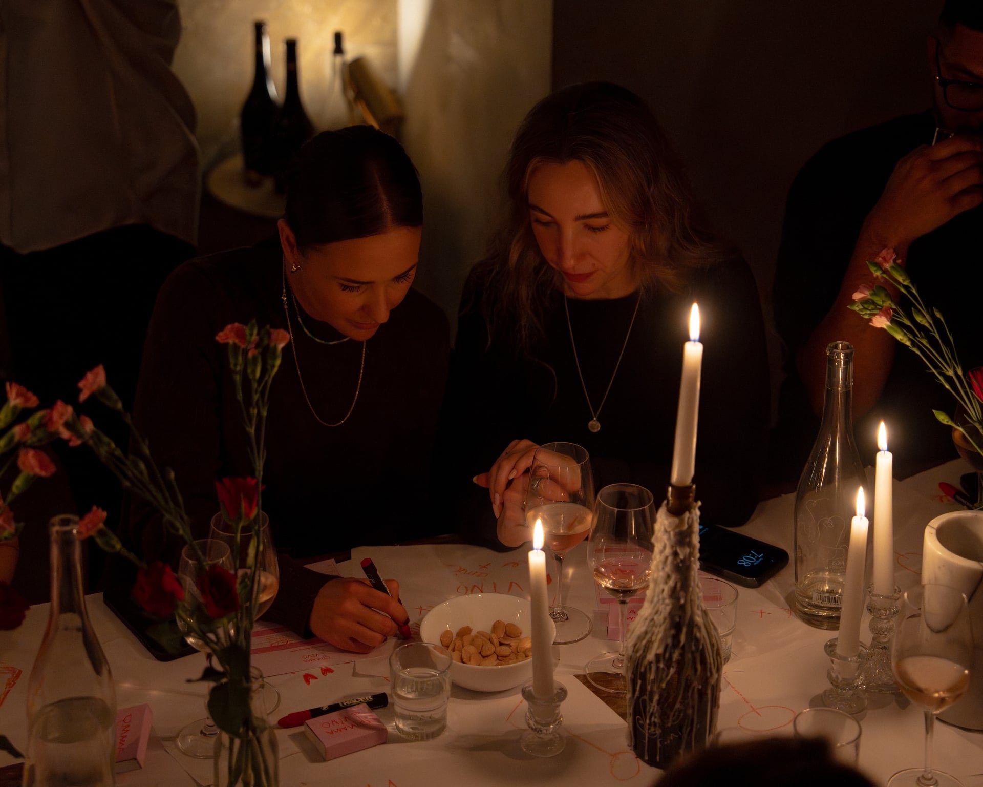 guests making wine tasting notes at table together