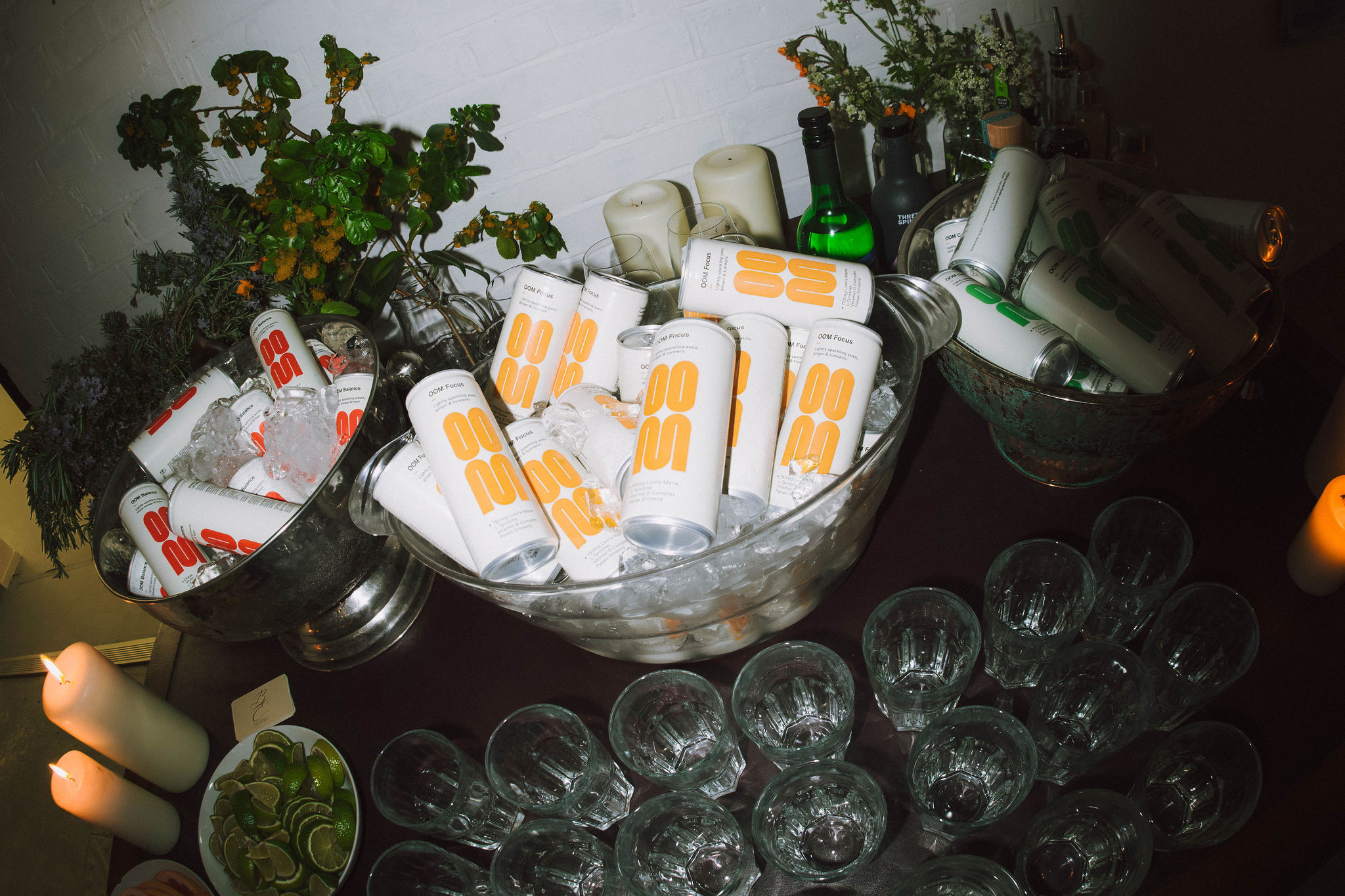 oom cans on table in ice buckets at brand event