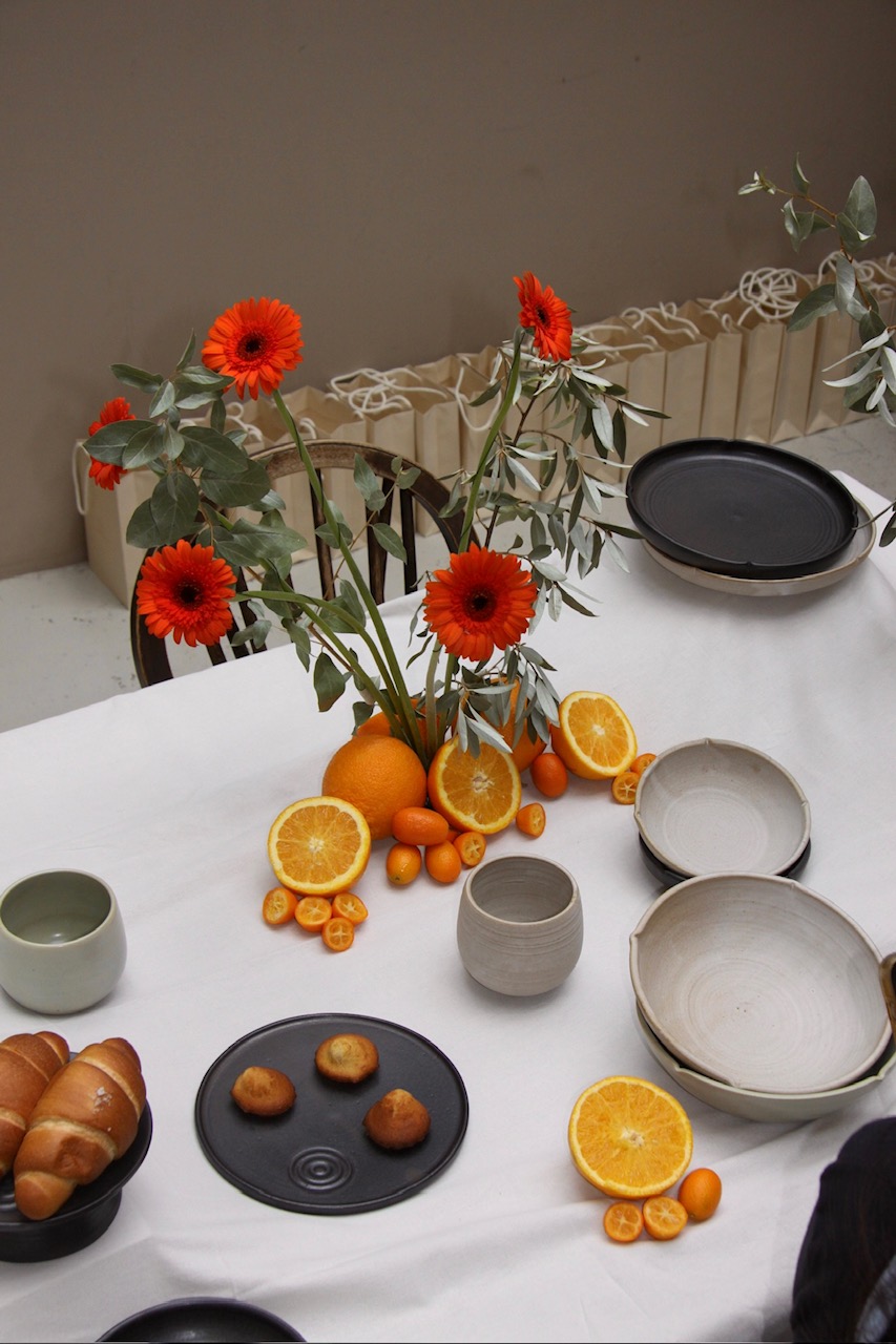 Close up shot of oranges and florals centrepiece for Cerani Studio japanese tableware launch
