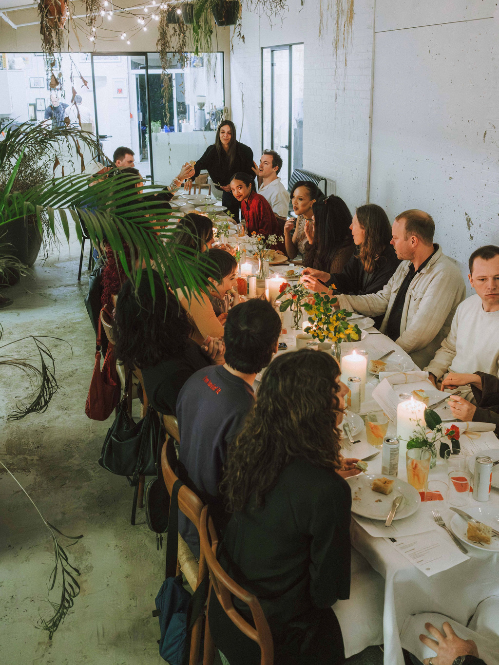 Guest sitting at a table for oom drinks community supper club